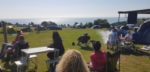 small group of people socialising without alcohol overlooking the sea